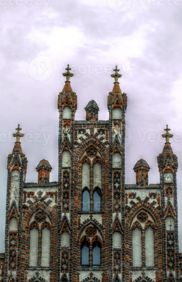 Top of a historic city center building in the style of brick gothic. This architectural style was used from the 12th to the 16th century. The image was created using a HDR imaging technique. photo