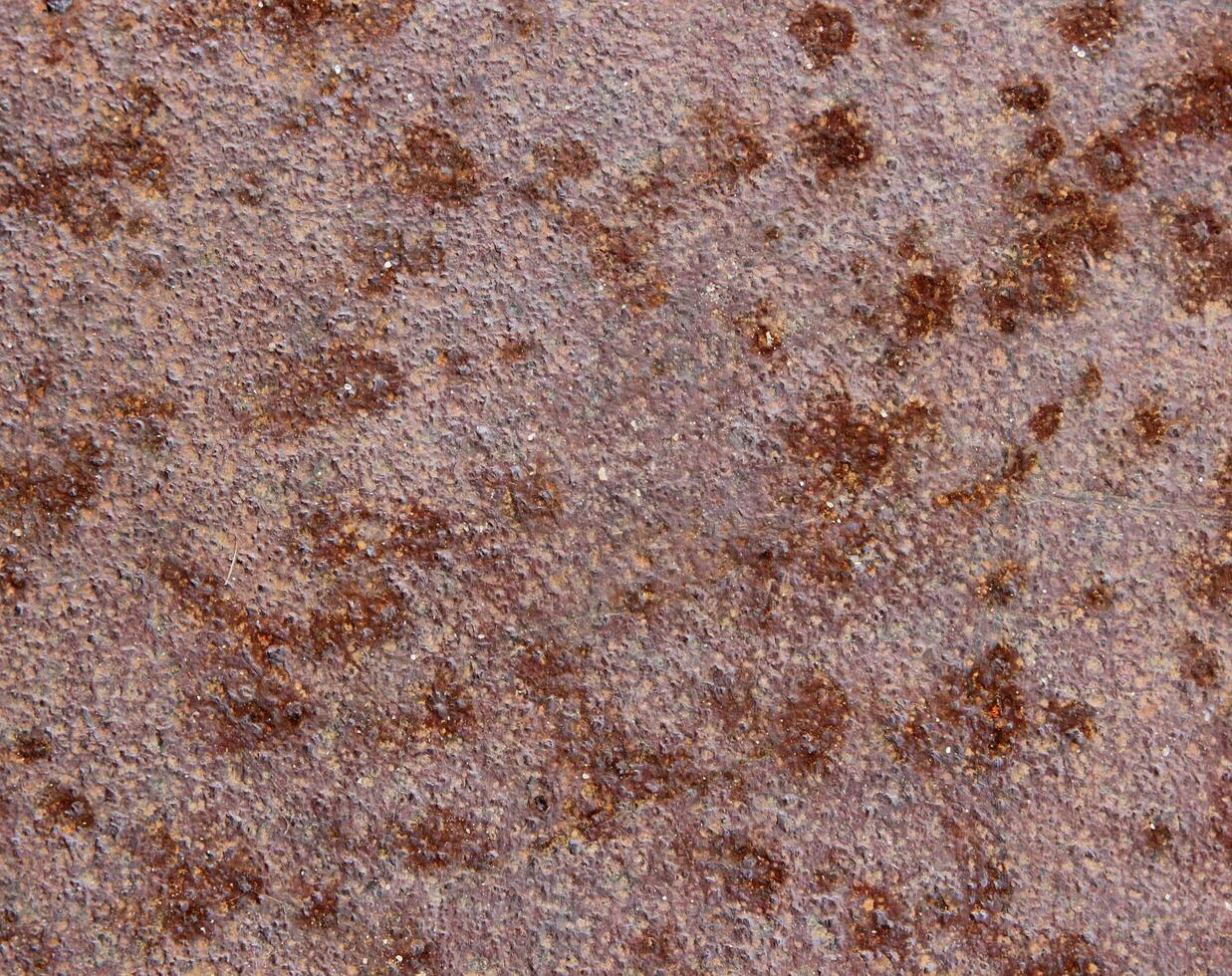 Macro of metal surface with rust speckles photo