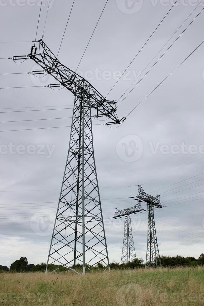 Three pillars of high voltage power lines in Mecklenburg-Vorpommern, Germany. photo