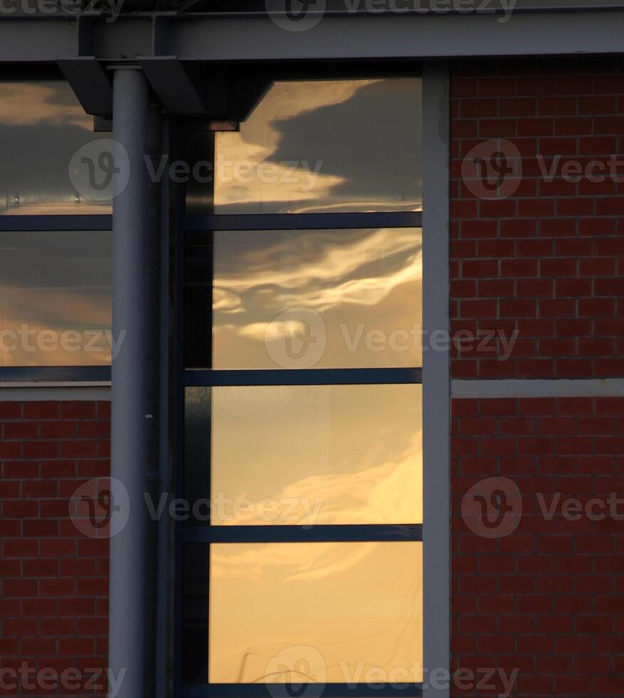 Windows with orange and blue reflection of sky in the evening. photo