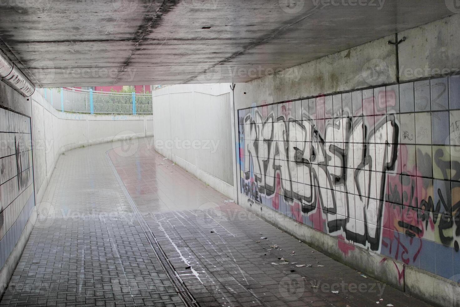Undercrossing with graffiti and garbage under a railroad in Greifswald, Mecklenburg-Vorpommern, Germany. Image was created using a HDR imaging technique. photo