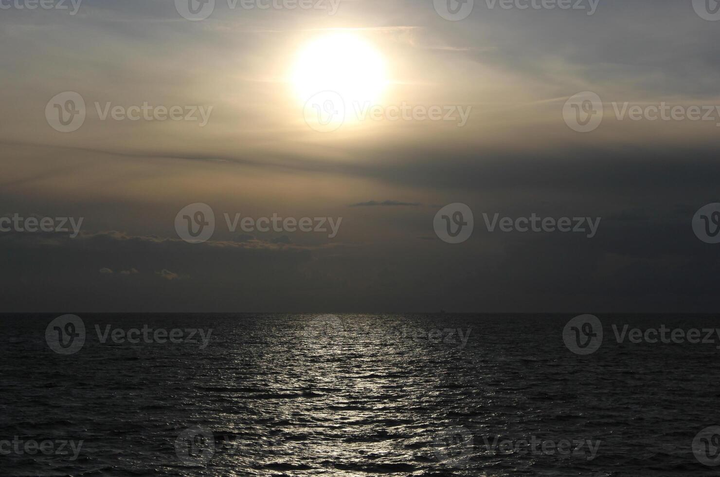 Misty sun over the open sea photo