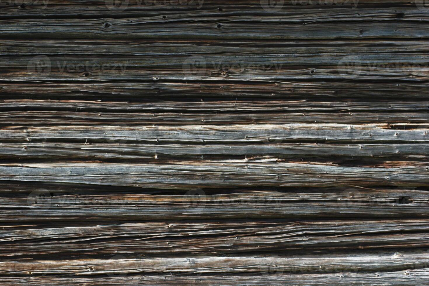 Dark weathered wooden texture of log cabin photo