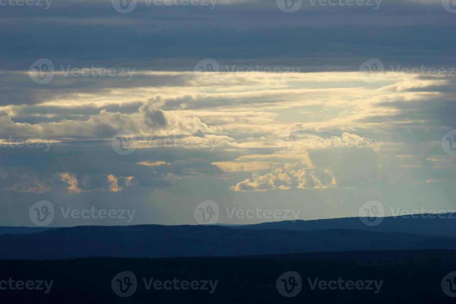 Different shades of blue and sunbeams seen from the mountain hstskr in Vrmland, Sweden. photo