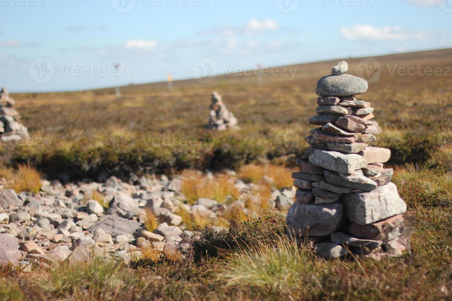 Stone piles built by tourists on a mountain. photo