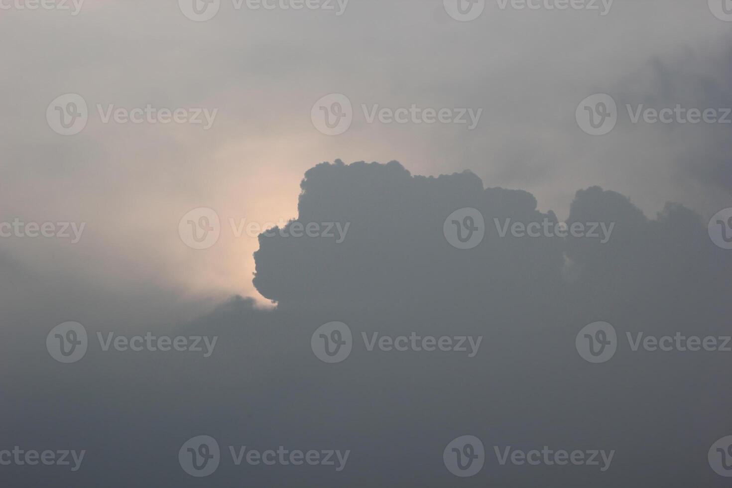 Sun glowing behing cloudscape. photo