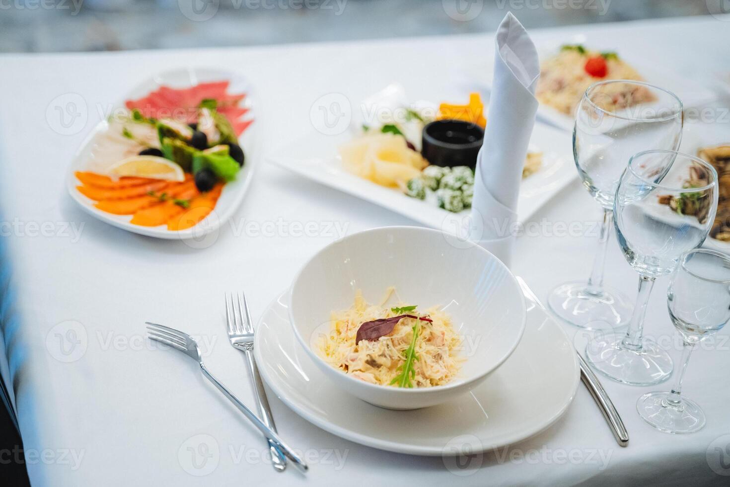 A beautifully arranged table displays a colorful variety of tasty food on elegant plates, with organized utensils, ready for a delightful meal or gathering with loved ones photo