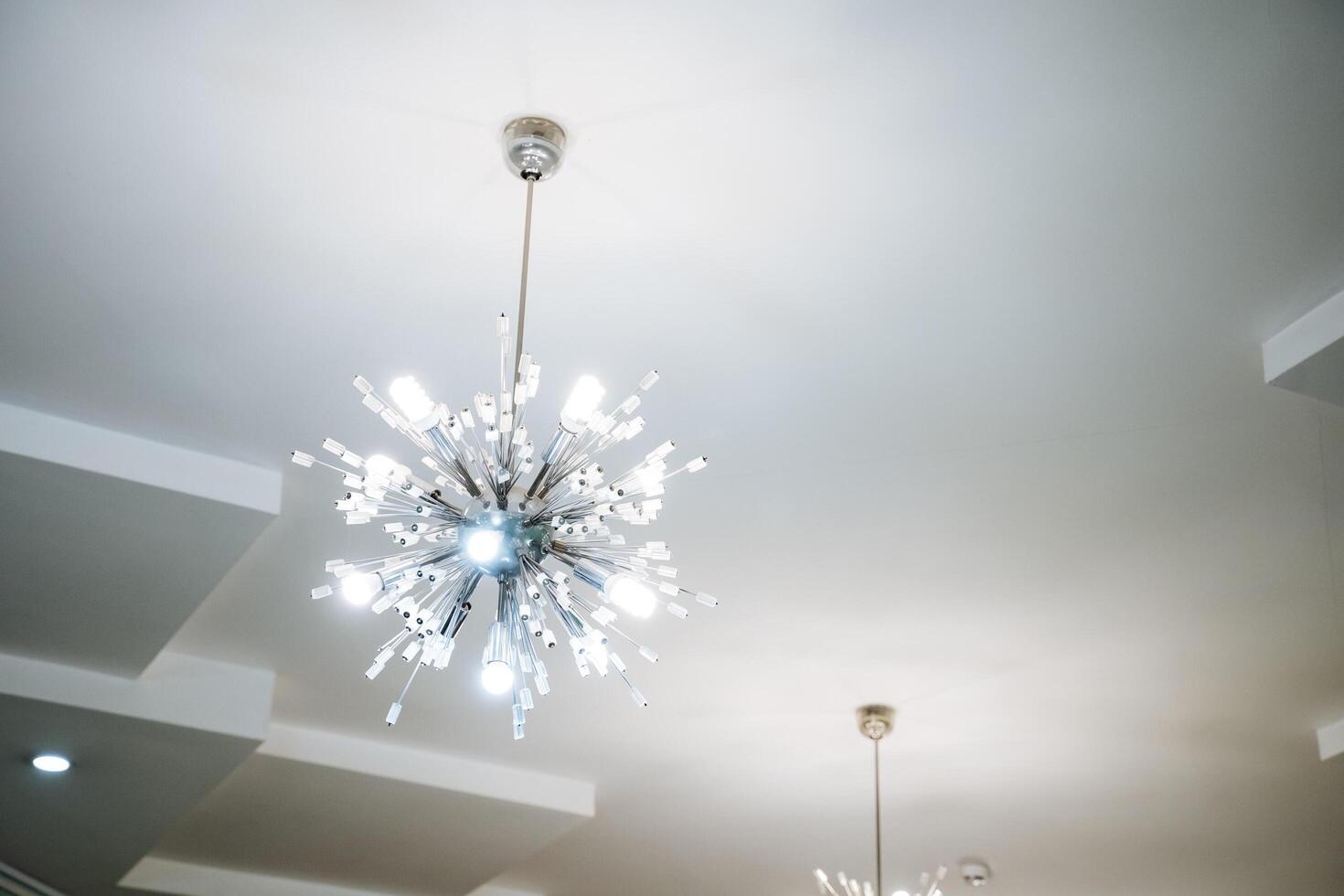 An Elegant and Modern Chandelier featuring a Radiant Light Fixture designed beautifully to enhance the appeal of any Contemporary Interior Space with its stunning design photo