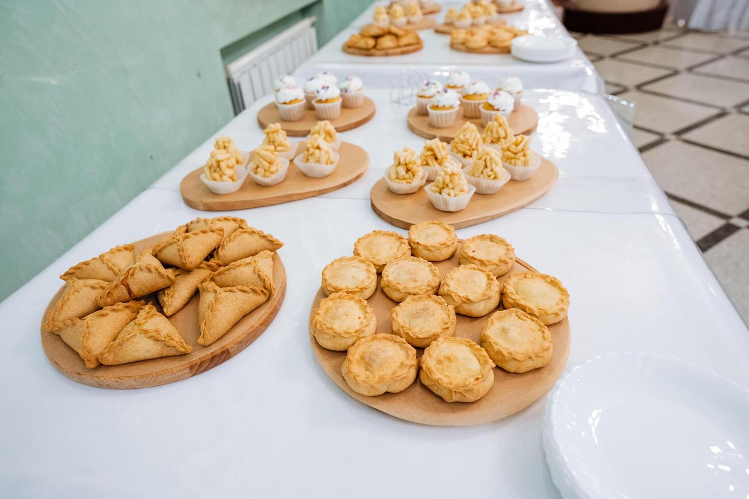 A wide variety of elegantly arranged and artistically presented food items on the beautifully set table looks enticing, delicious, and appetizing for everyone to enjoy and savor photo
