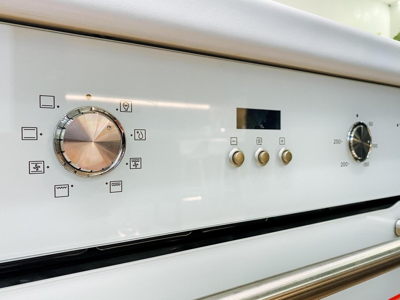 A detailed closeup view of a pristine white oven that features a clock prominently displayed on its surface, showcasing its timekeeping functionality as a home appliance photo