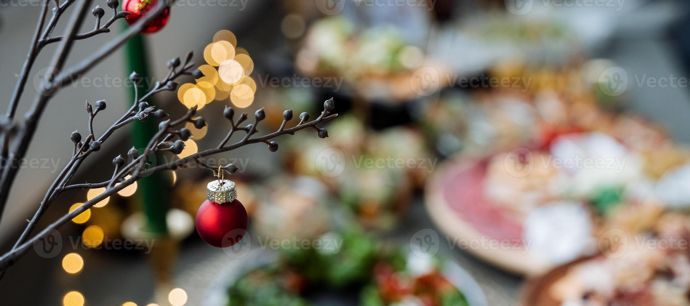 A beautifully decorated Christmas tree with sparkling ornaments sits atop a table full of delicious pizzas, creating a joyous festive atmosphere for everyone to enjoy together photo