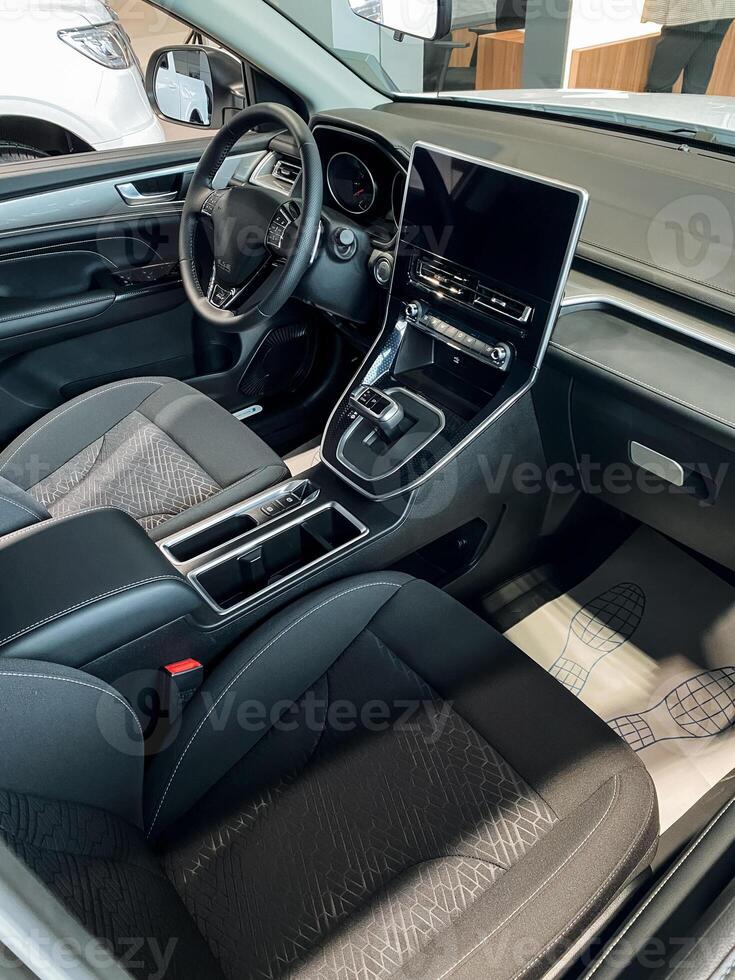 The interior design of a modern car featuring a sleek tablet conveniently positioned on the dashboard, enhancing the overall technological experience for the driver and passengers photo