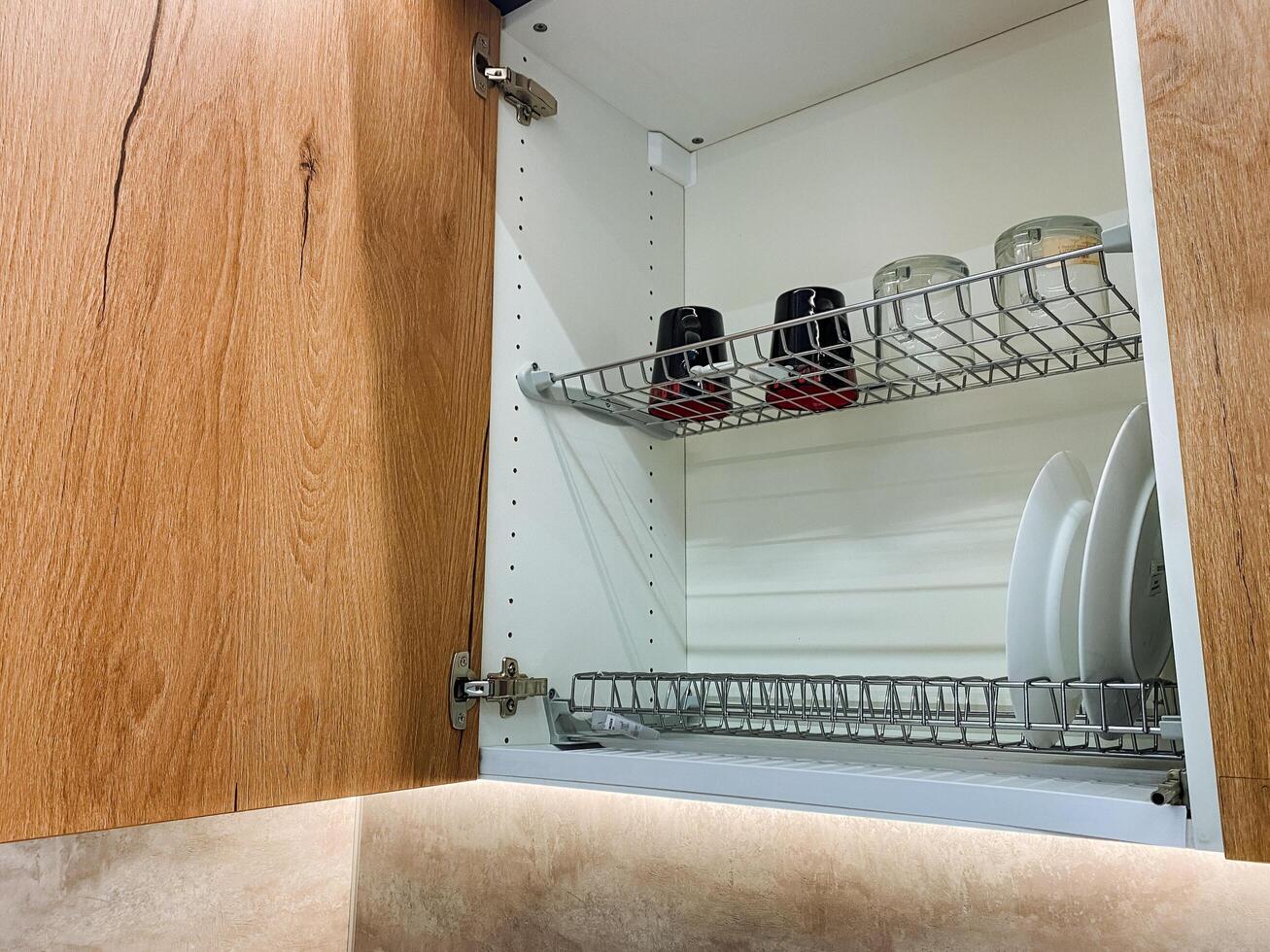This elegantly designed kitchen cabinet features an integrated dish drying rack for excellent functionality and convenience, making dish drying a seamless task in your home photo
