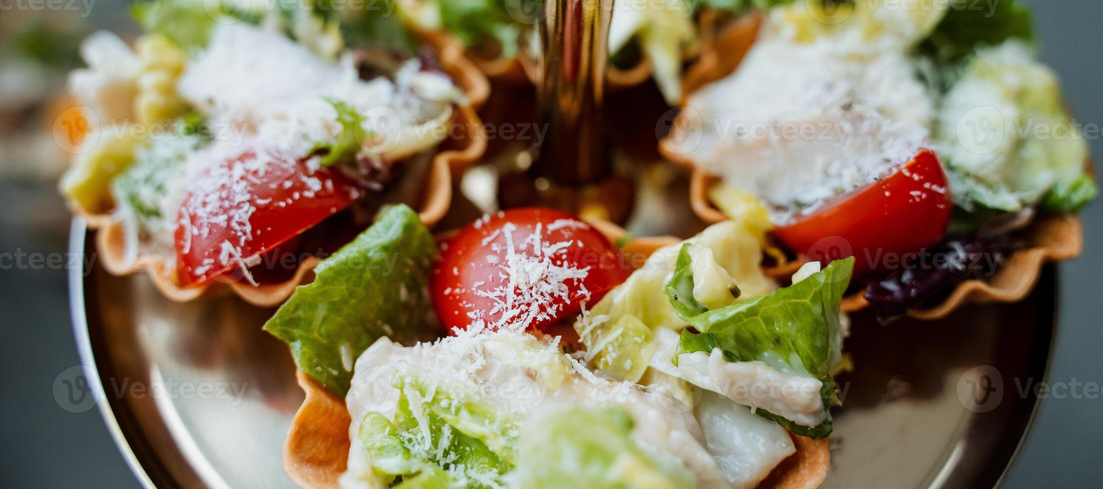 This vibrant and colorful closeup image showcases a delicious salad served in a crispy waffle cup, complete with a shiny fork, enticing you to savor the delightful flavors in each bite photo