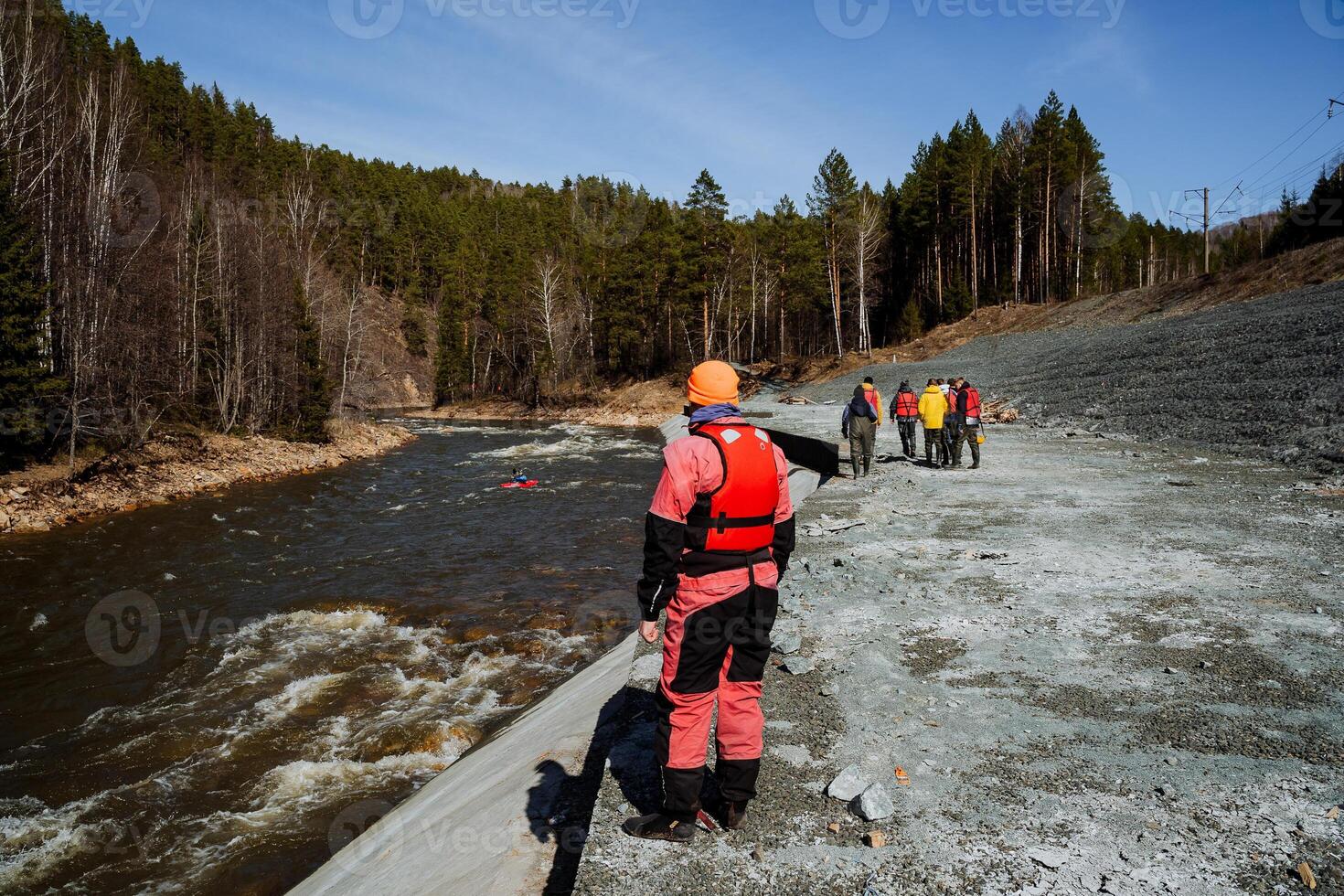 A beautifully diverse group of close friends leisurely strolls along a picturesque river, enjoying the stunning scenery and having a delightful time together outdoors in natures embrace photo