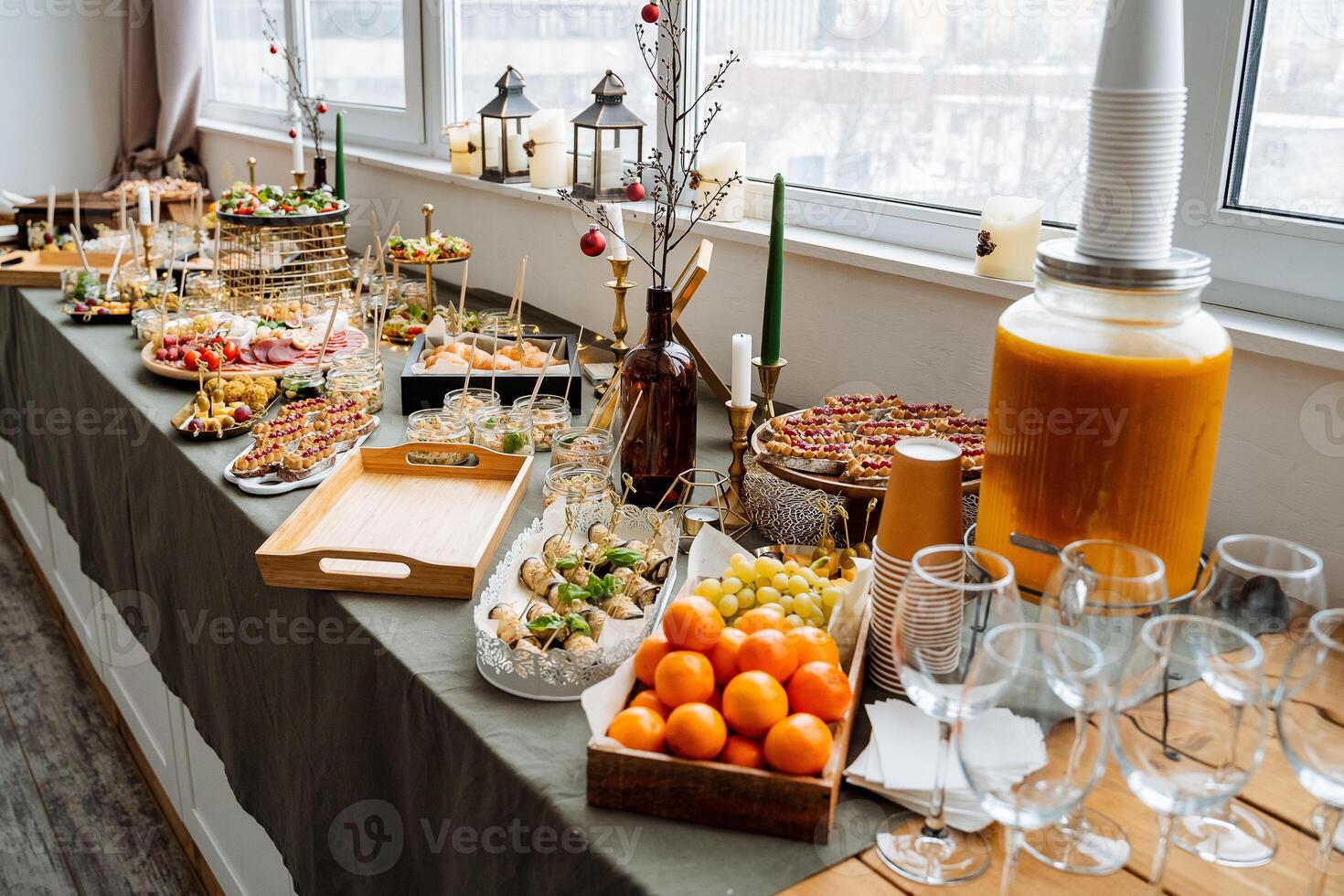A beautifully arranged buffet table that showcases a diverse assortment of delectable food items along with an impressive selection of beverages elegantly displayed on it for all to enjoy photo