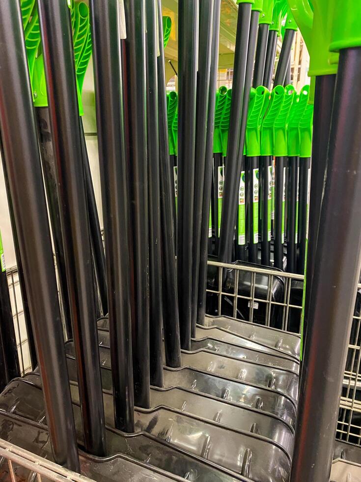 A collection of pens, each with green tops, is currently resting on a rack, ready for use or to be organized for better accessibility and display. They are possibly various types photo