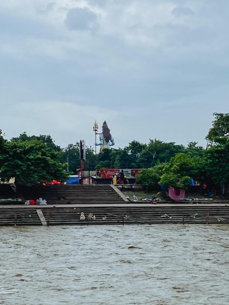 A vast and expansive body of water is beautifully surrounded by a variety of trees and structures, all coming together to create a picturesque view beneath a cloudy sky on this lovely day photo