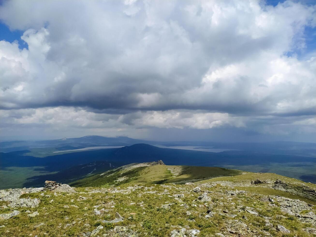 From a scenic hilltop, one can truly admire the stunning panoramic view of a majestic mountain range, showcasing incredible natural beauty in every possible direction all around photo