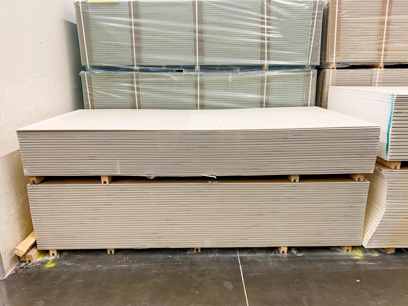 A carefully stacked arrangement of drywall sheets forms a robust and sturdy structure, which is constructed from this essential and widely utilized building material known in the industry photo