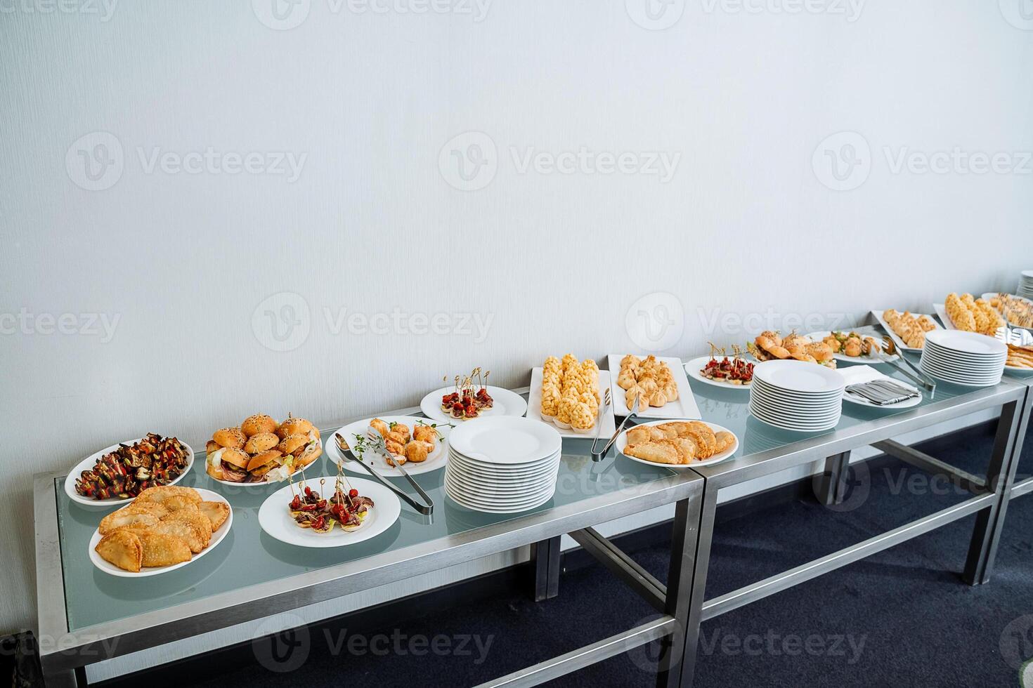 A beautifully arranged table is elegantly set with an array of delicious food, inviting everyone to gather around and share in the joy and warmth of a wonderful meal together photo