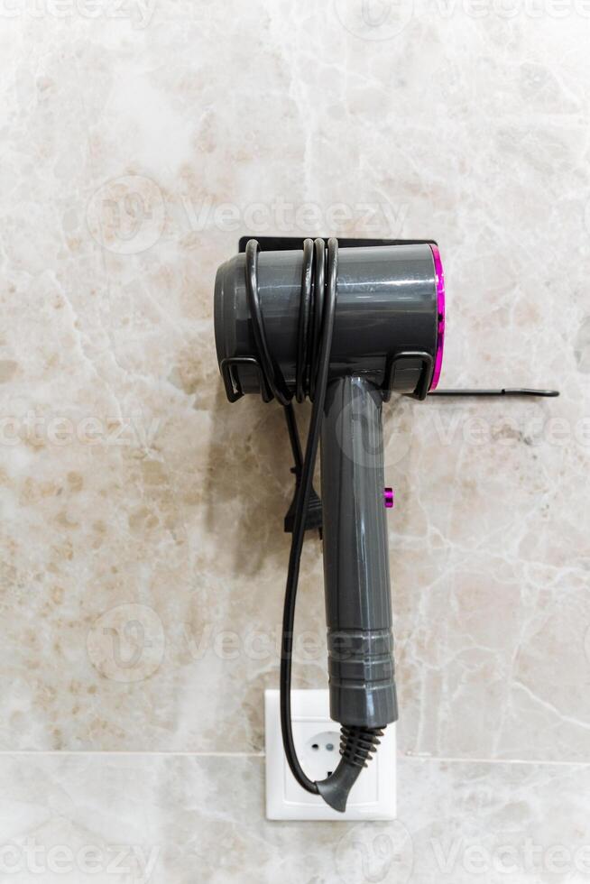 A hair dryer represents a typical household appliance that conveniently plugs into an electrical outlet, delivering the necessary power required for its effective and efficient operation photo