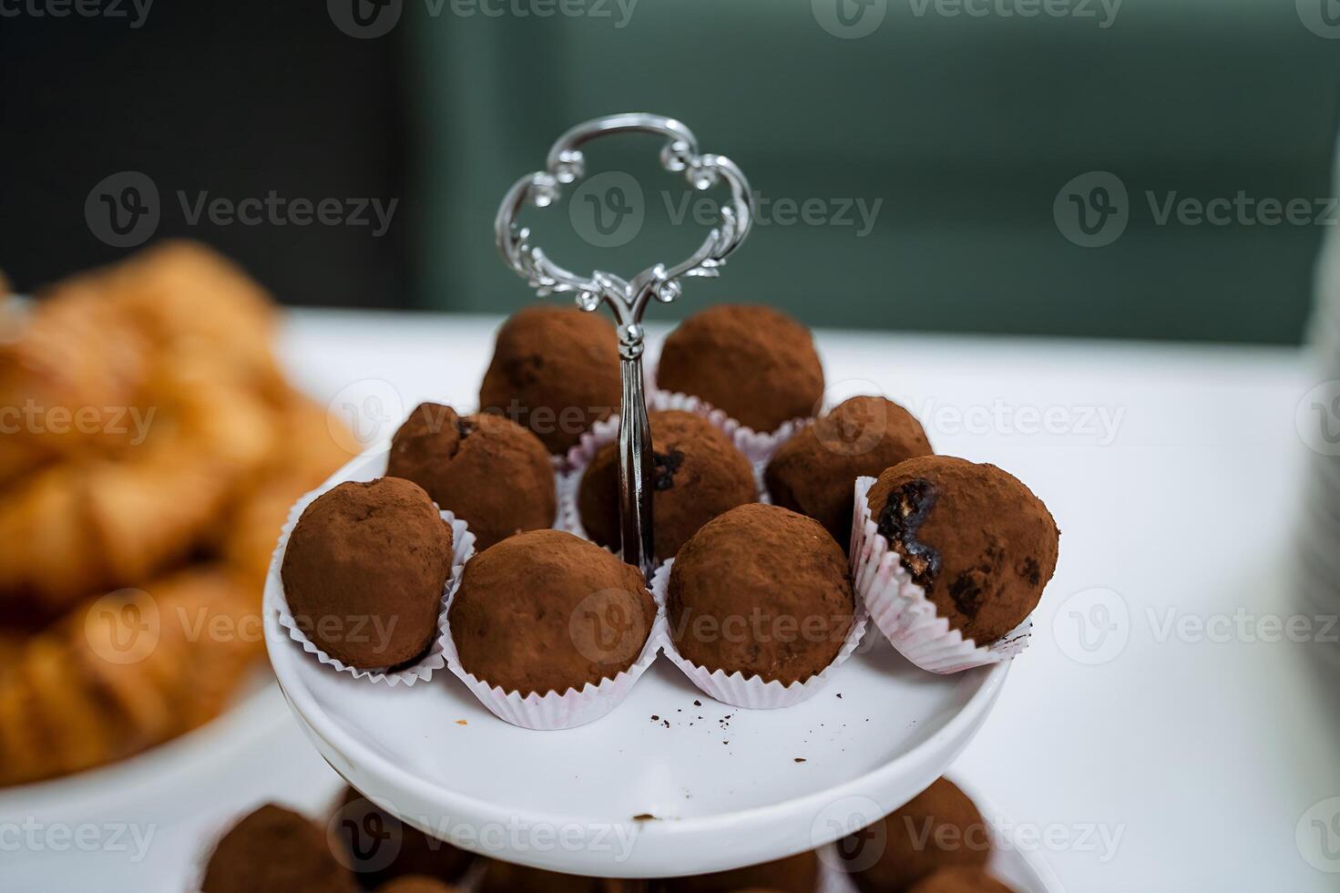 A white plate elegantly showcases chocolate truffles, a tempting dessert treat, creating a delightful presentation on the table for dessert lovers to enjoy the rich and indulgent flavors photo