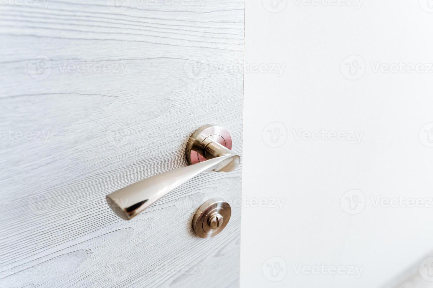 A nickel circle door handle on a white door, enhancing the hardwood flooring photo