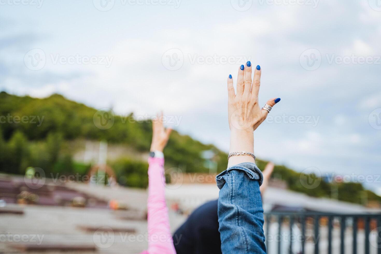 Celebrating Freedom Hands Raised in Unity Against a Beautiful and Scenic Background of Nature and Joyous Togetherness photo