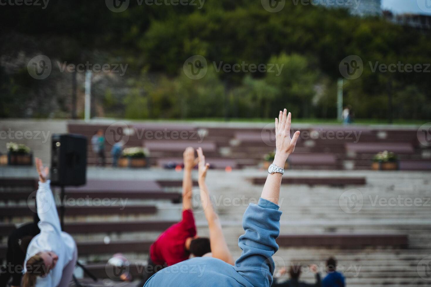 Individuals Actively Participating in a Group Activity at a Vibrant Outdoor Venue Surrounded by Nature and Community photo