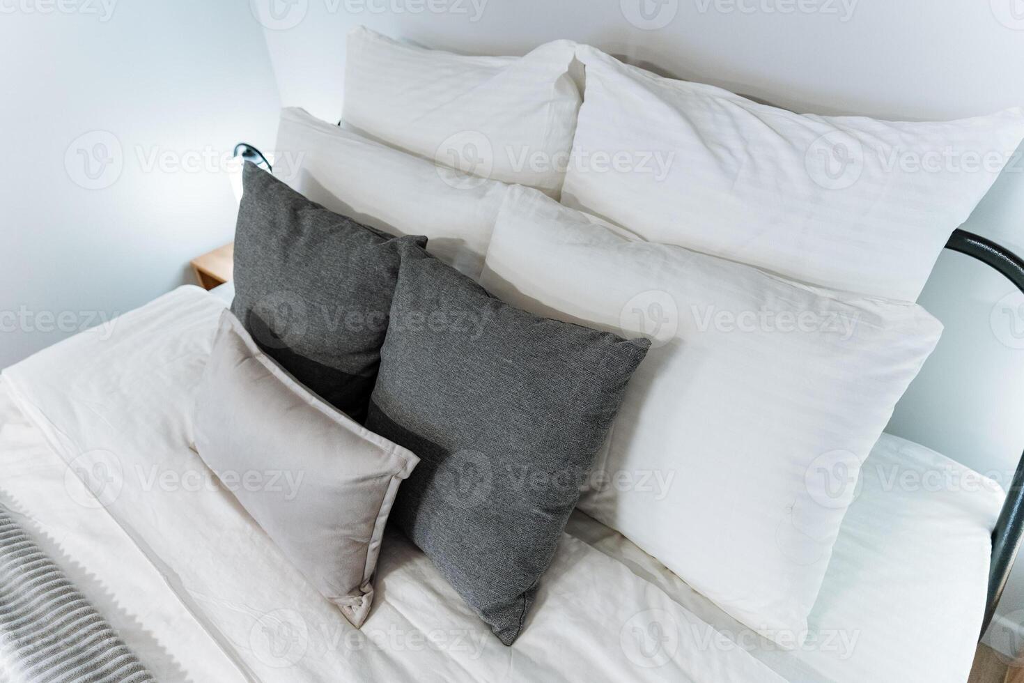 A comfortable bed featuring crisp white sheets along with fluffy pillows neatly arranged on it, creating a cozy and inviting atmosphere that beckons for a restful nights sleep photo
