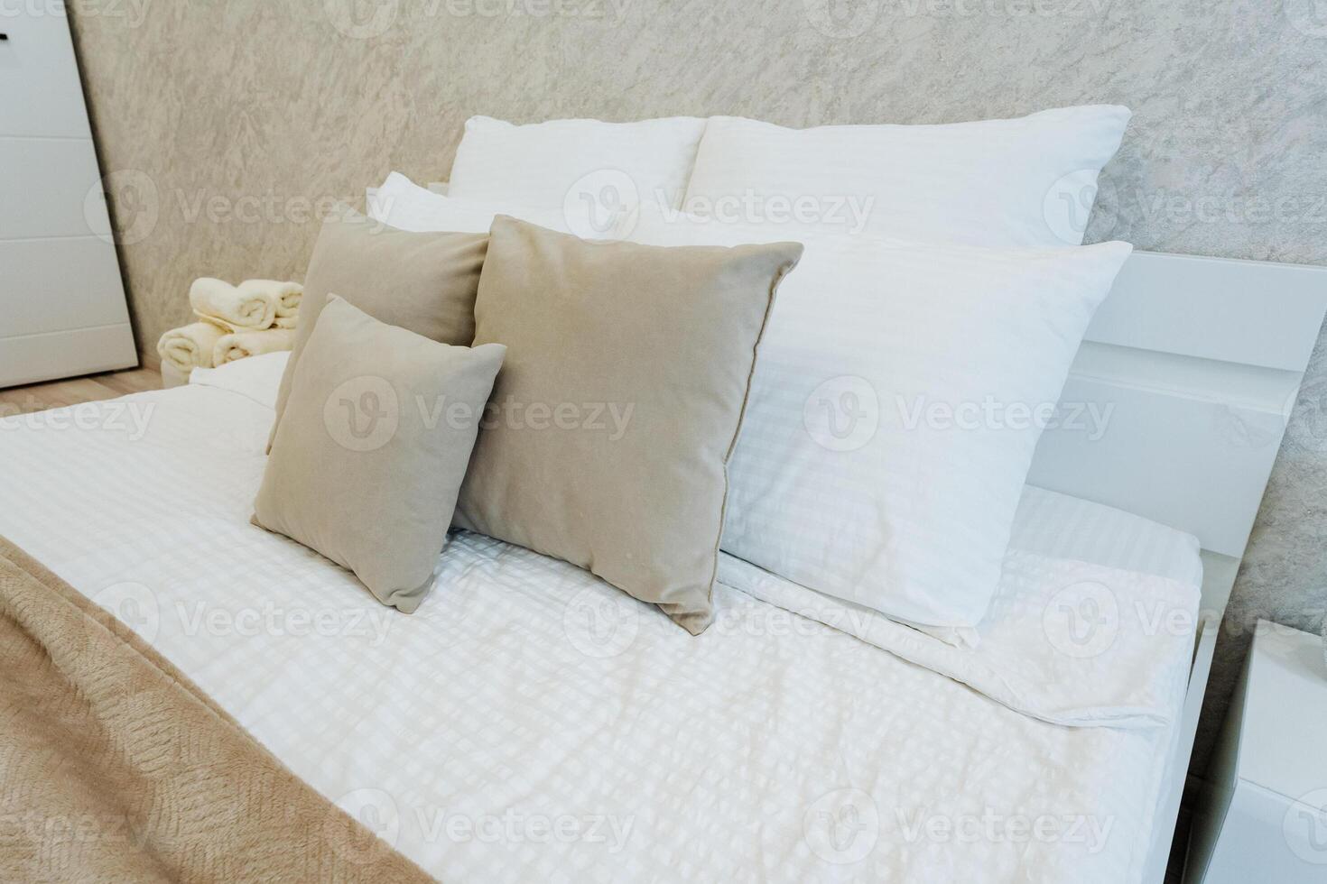 Experience the ultimate in relaxation with a cozy bed adorned with plush pillows and soft bedding, all set within a modern bedroom ambiance that exudes comfort and style photo