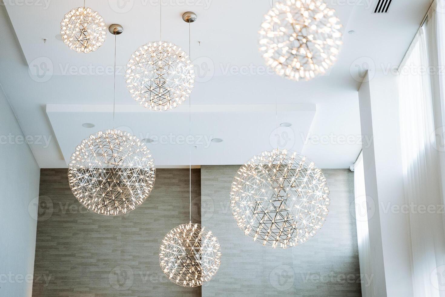 Discover the beauty of elegant modern chandeliers that perfectly complement a contemporary interior space, enhancing its overall aesthetic photo