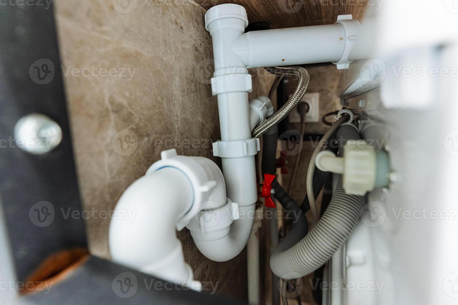 This image features a detailed closeup view of a sink pipe within a bathroom setting, showcasing the intricate design and mechanisms that ensure proper drainage functionality photo