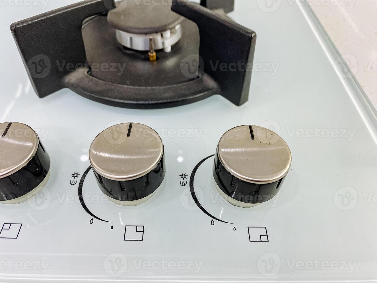 This image shows a detailed closeup view of a gas stove featuring four distinct knobs on its surface, which are used to control the burners on this essential kitchen appliance photo