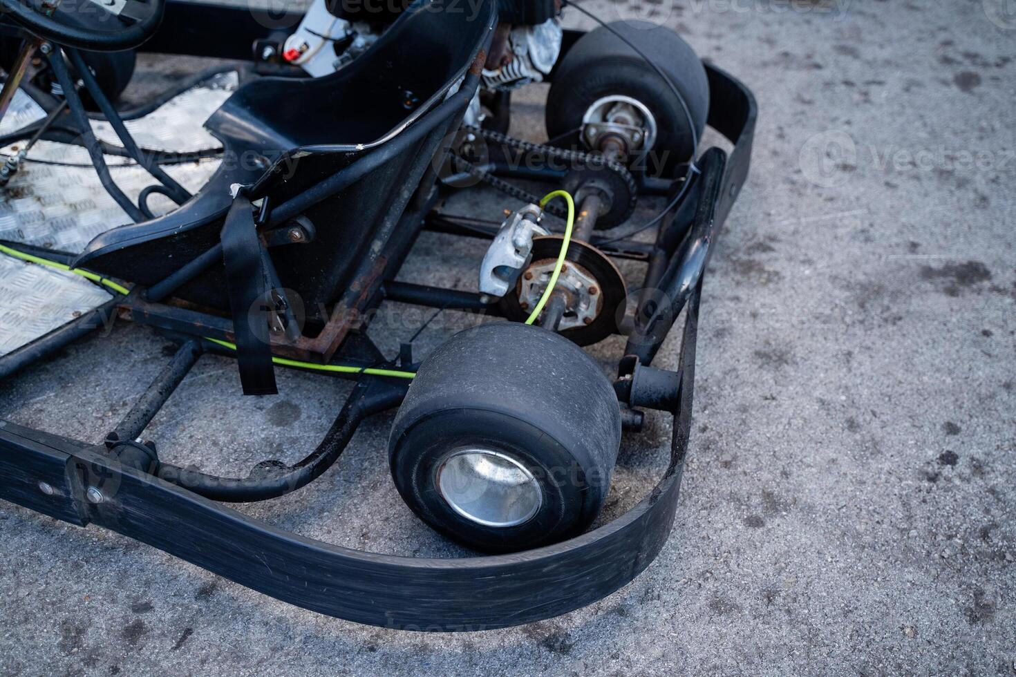 A gokart is currently parked on the side of the road, resting quietly on its wheels, showcasing its unique design and features, capturing the attention of passersby and enthusiasts alike photo