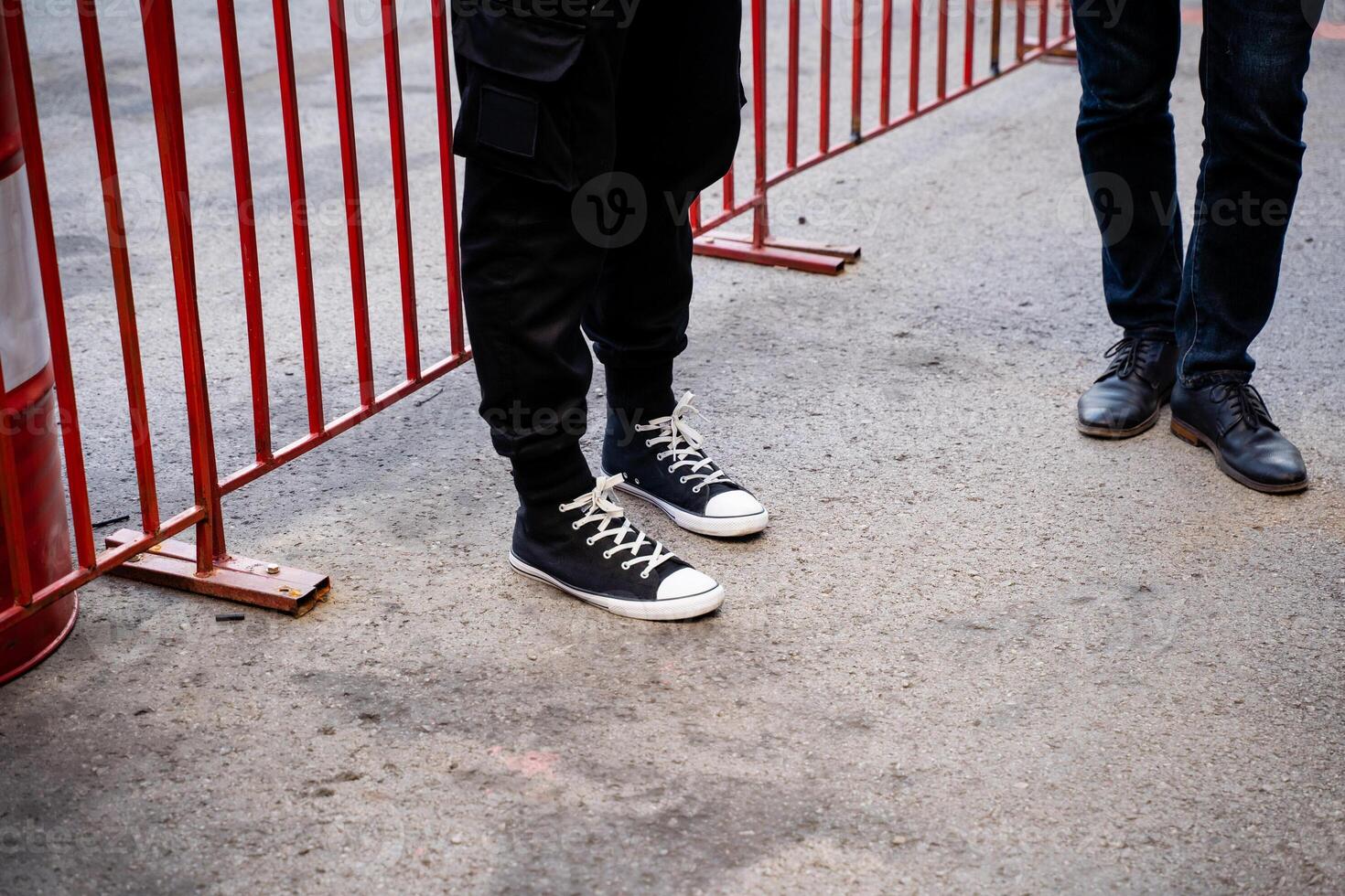 Casual Footwear Choices Seen at a Public Event Where Barricades Were Set Up for Crowd Control and Safety photo
