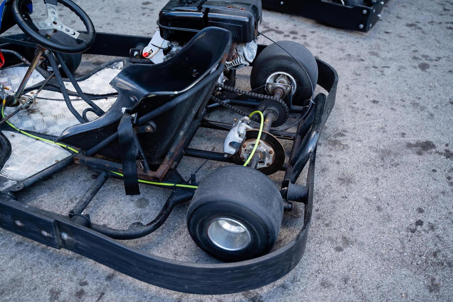 A go kart is currently parked on the side of the road, waiting for its next ride or adventure. It is a small, fast vehicle commonly enjoyed in racing scenarios or recreational areas photo