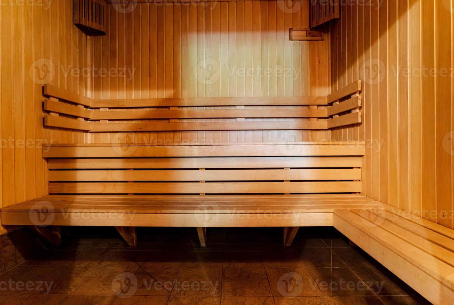 The sauna is constructed entirely from wood, featuring sturdy wooden benches and a beautifully finished wooden floor that enhances the overall aesthetic and ambiance of the space photo