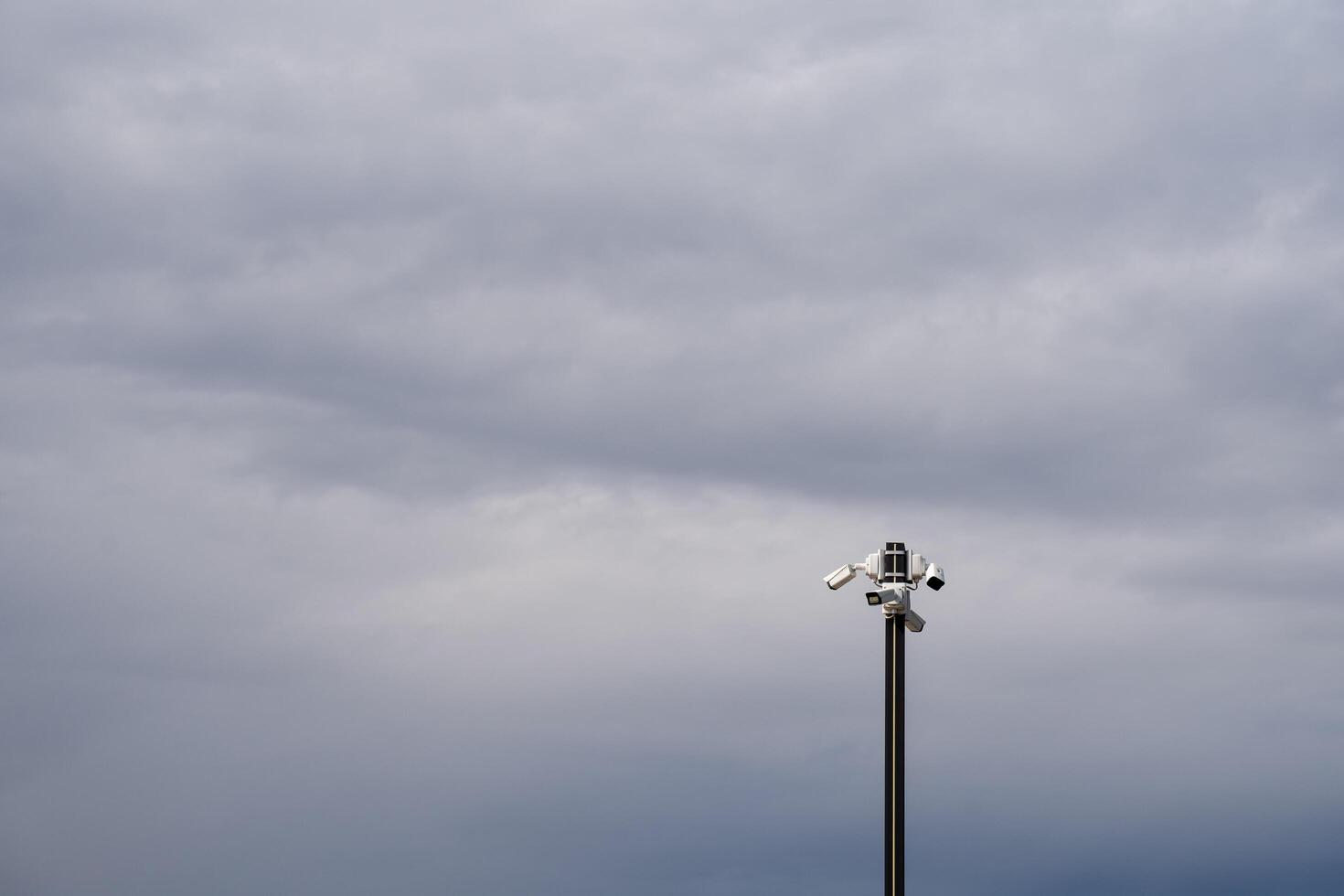 A Dramatic Sky Featuring a Light Pole in an Overcast Environment That Enhances the Overall Atmosphere and Mood photo