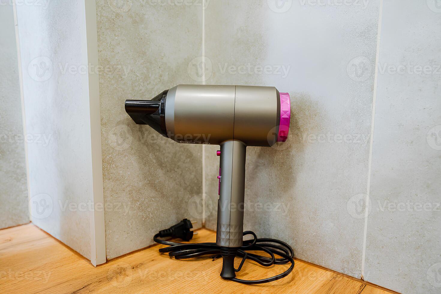The hardwood flooring stands out in the room next to the wall housing a hair dryer, creating a captivating mix of textures and materials that enhances the overall aesthetic of the space photo