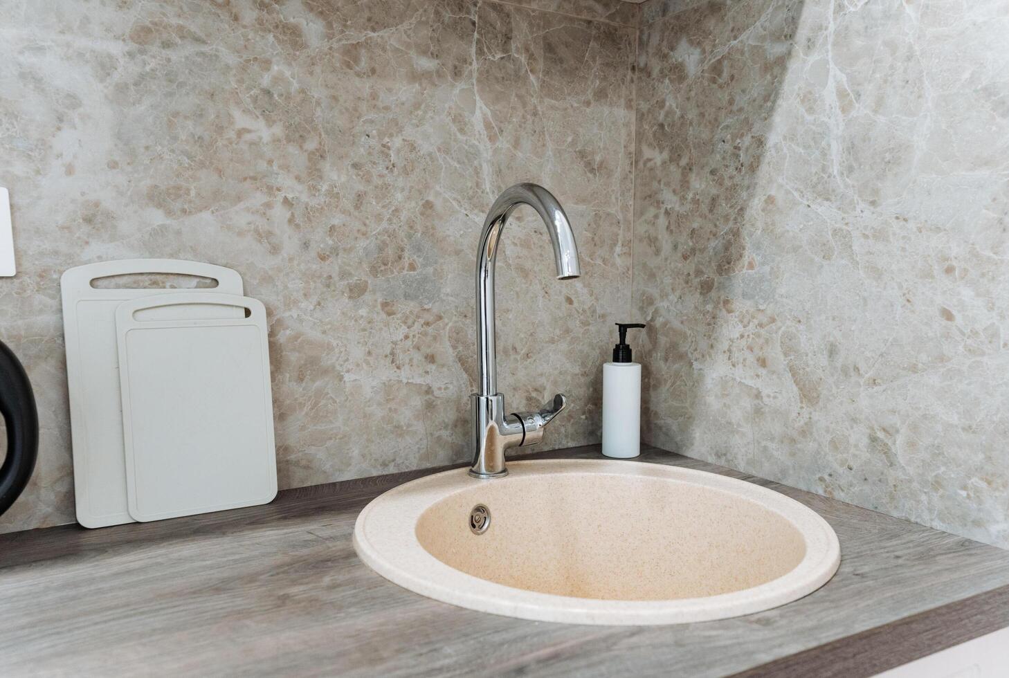 Experience a Stylish and Modern Kitchen Sink featuring an Elegant Design along with a Minimalist Aesthetic for your cooking space photo