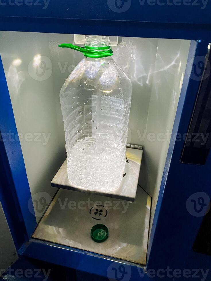A waterfilled bottle sitting prominently on a machine emphasizes the essential and practical role of drinkware in our daily routine, ensuring convenient access to hydration whenever needed photo