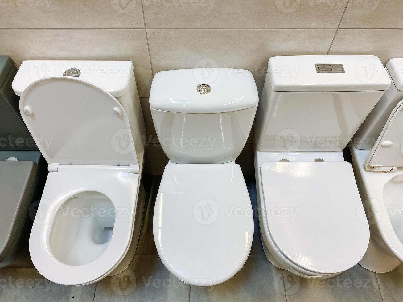 In the spacious and welldesigned bathroom, a neat row of gleaming white toilets is perfectly aligned, ensuring maximum convenience and comfort for all users to enjoy their experience photo
