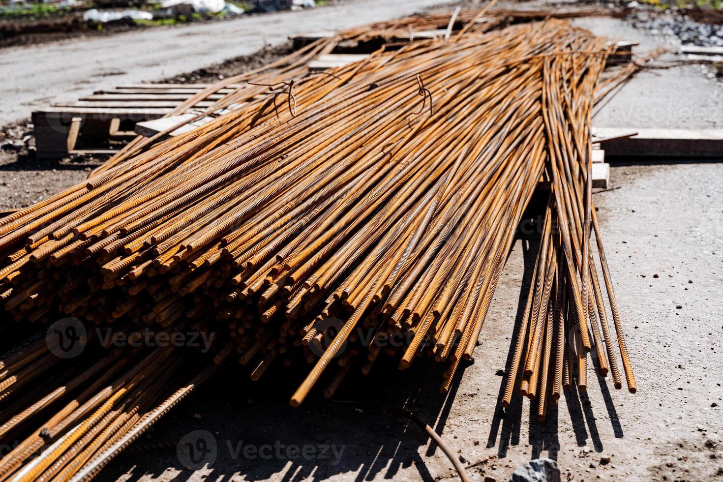 Rusty steel rebars stacked at construction site, essential building materials for reinforced concrete. Raw materials for infrastructure development in industrial projects photo