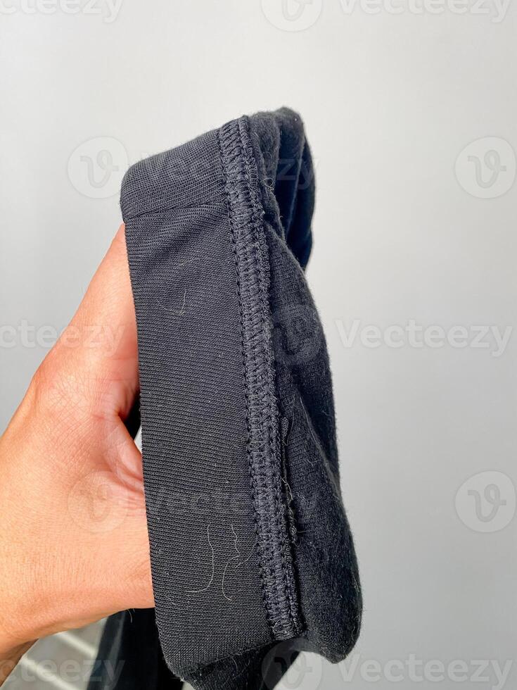A person is holding a large piece of black fabric in their hand photo