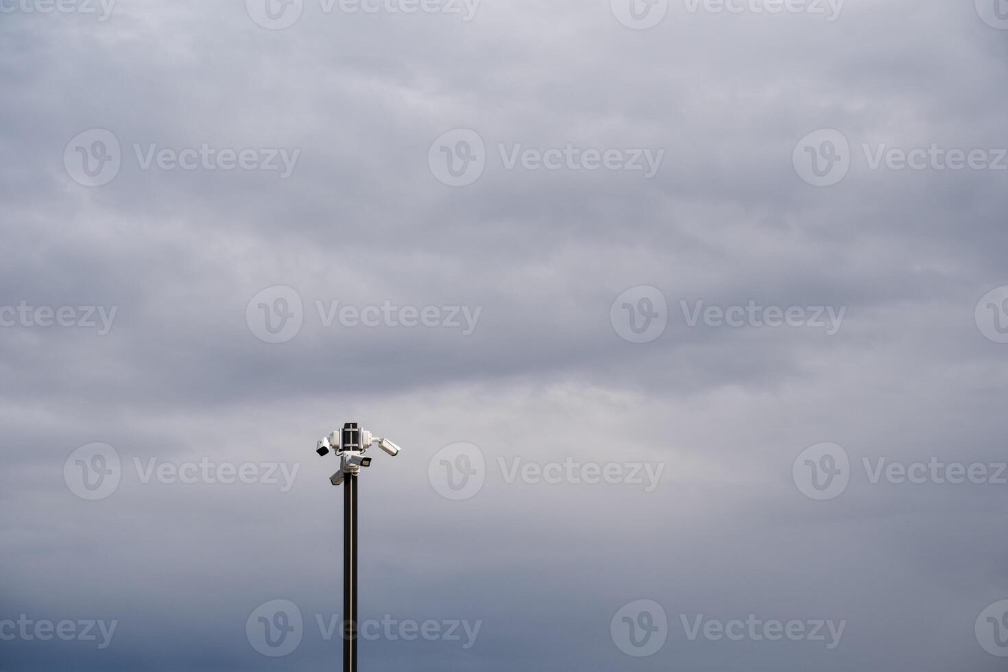 A strong and durable metal pole equipped with a highdefinition camera diligently captures the breathtaking beauty of the sky along with the picturesque landscape that surrounds it photo