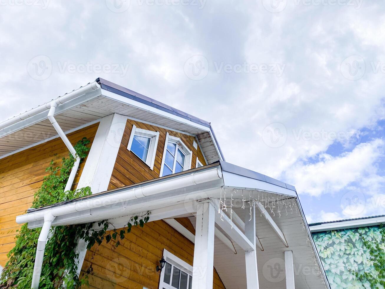 A Beautiful and Charming Modern House Showcases Unique Architectural Features Set Against a Striking Dramatic Sky Background, Perfect for Photography Enthusiasts photo