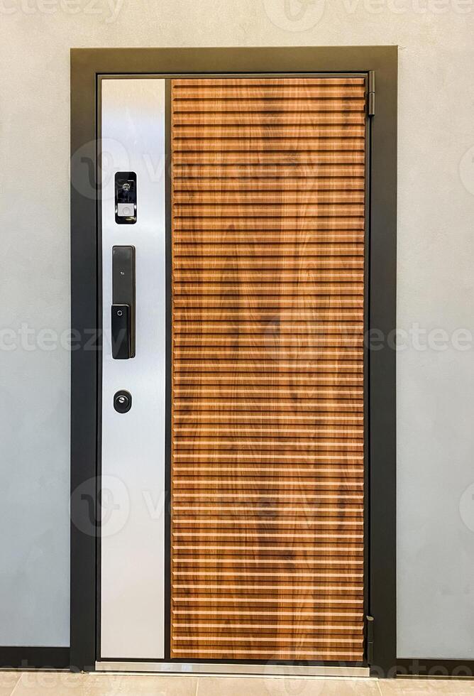 This is a beautifully crafted wooden door that is elegantly complemented by a sturdy stainless steel frame, bringing together both aesthetic appeal and functional durability for any space photo