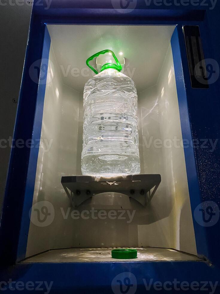 An impressive Water Dispenser that features a large, clear plastic bottle placed conveniently in a builtin cooling chamber for optimal freshness photo